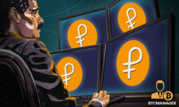 Maduro sitting infront of Petro coins on computer screens