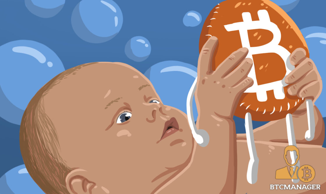 A baby holding a Bitcoin