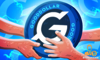 Gooddollar coin being held by hands