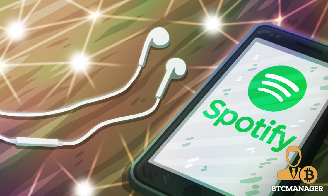 a mobile with spotify and earphones